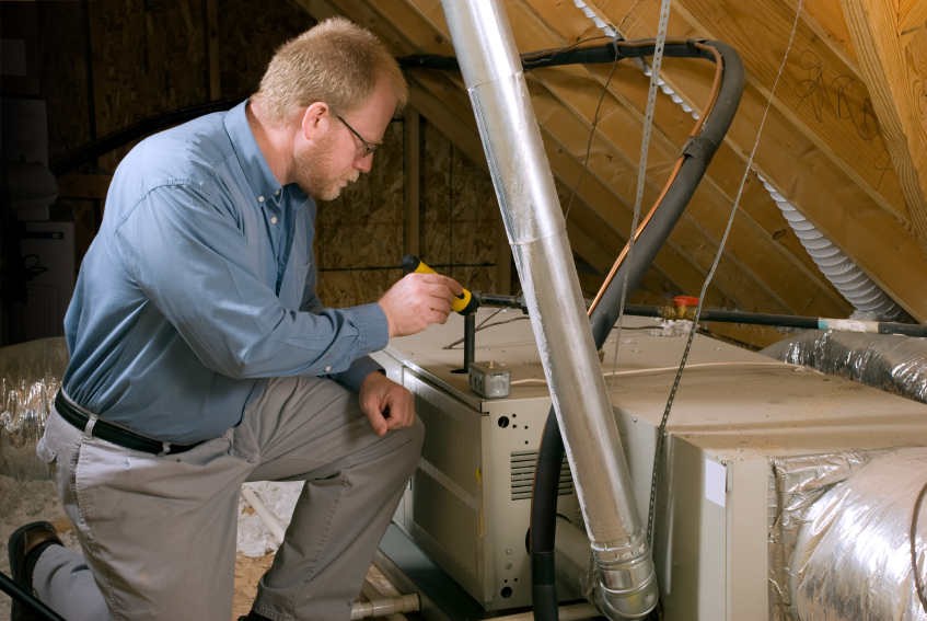 Photo of a technician inspecting a furnace